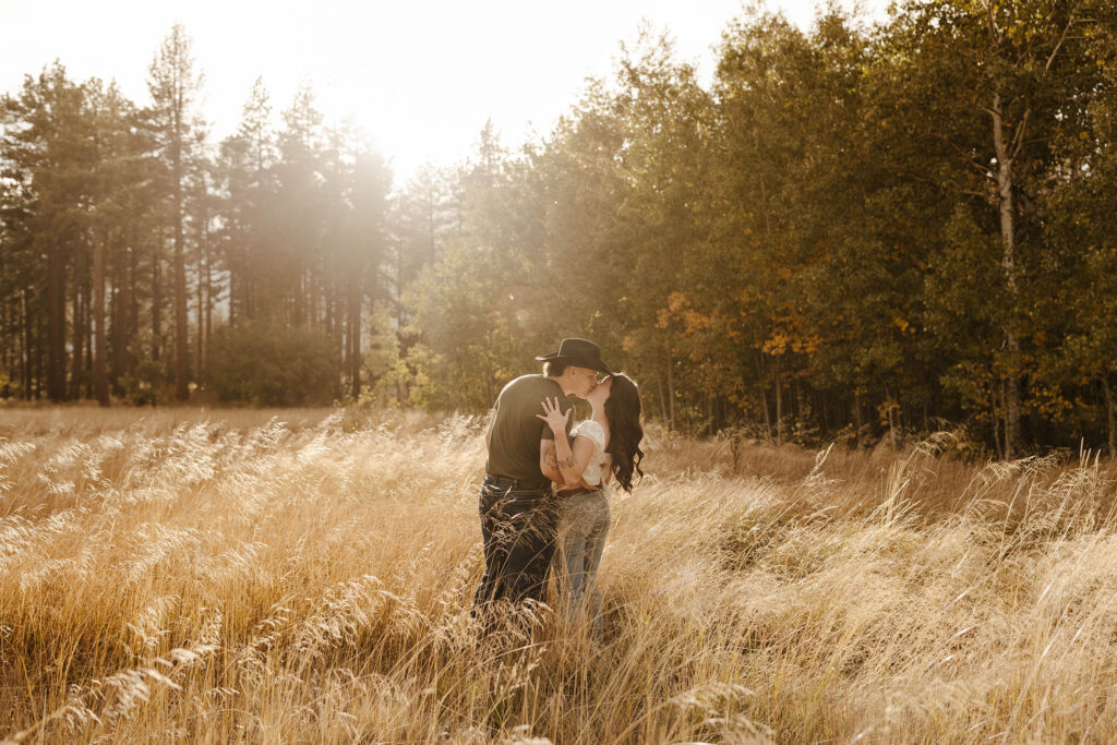 engagement couple kissing in a golden meadow in south lake tahoe