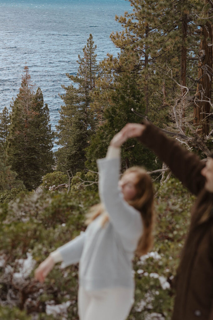 couple dancing in the distance with lake tahoe in focus