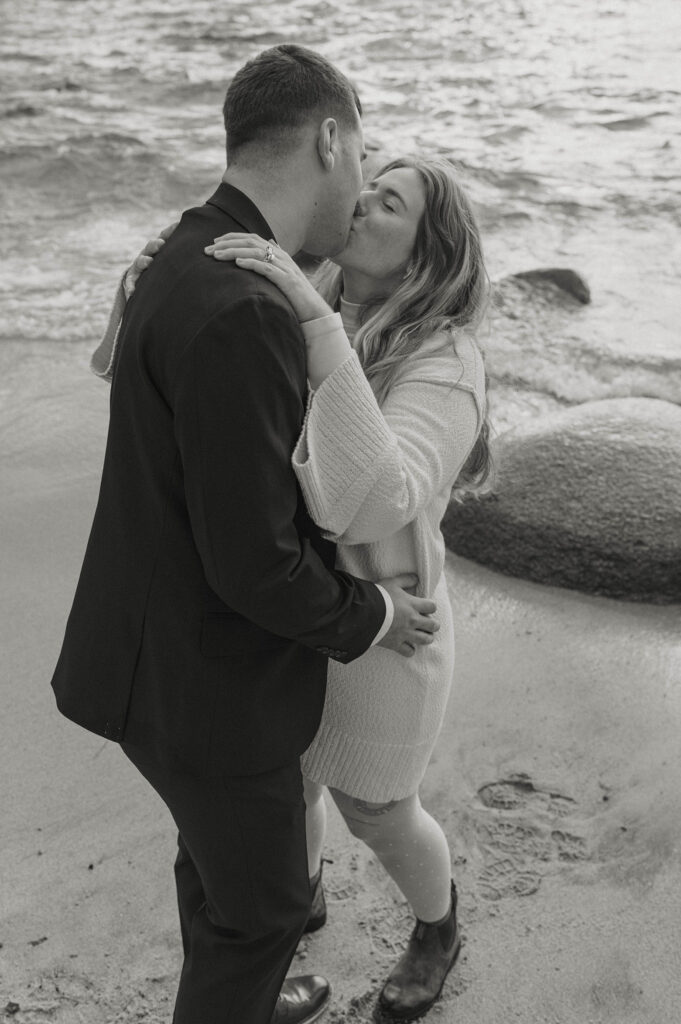 couple kissing on a beach in lake tahoe