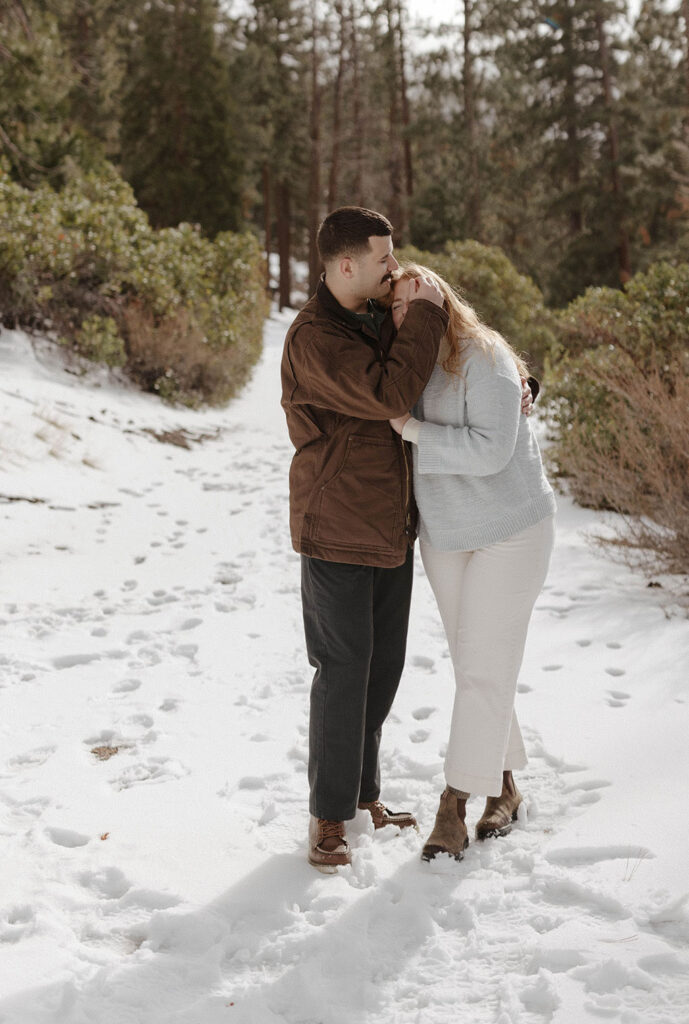 couple hugging in the snow in lake tahoe