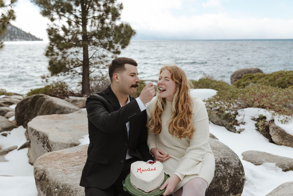 couple eating married cake together in lake tahoe