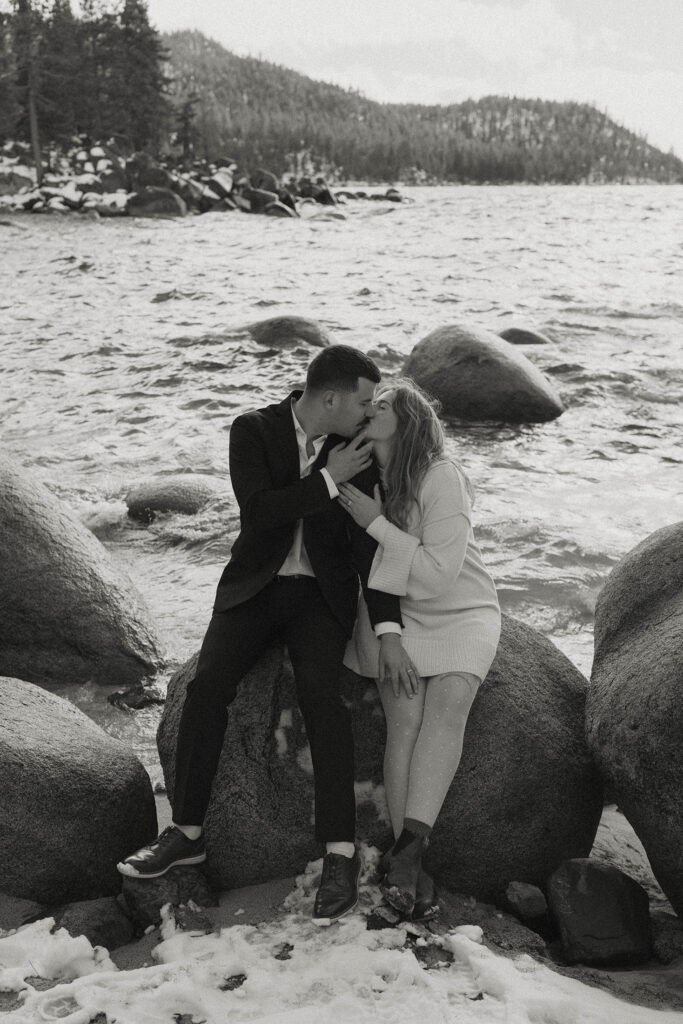 couple kissing on a rock in lake tahoe