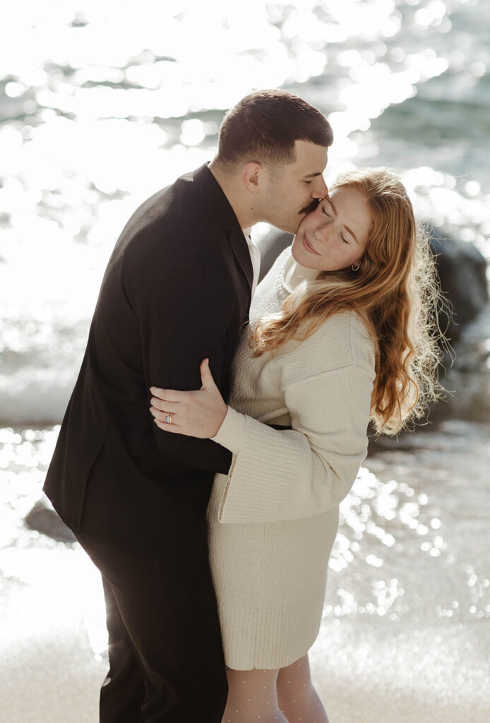 man kissing woman's cheek in lake tahoe