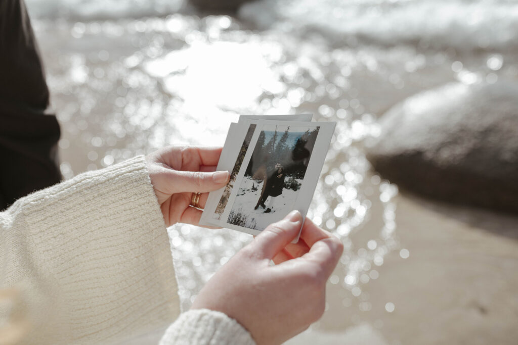 woman holding polaroid photos from her lake tahoe anniversay photo shoot