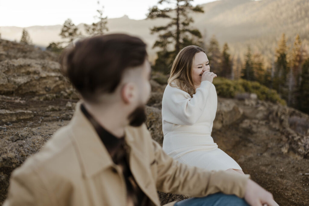 woman laughing and in focus while man looks at her out of focus at eagle rock