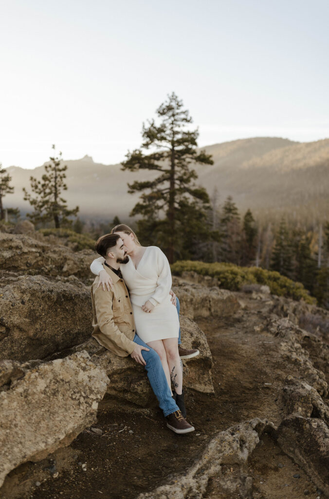 engagement couple sitting on rocks at eagle rock, lake tahoe