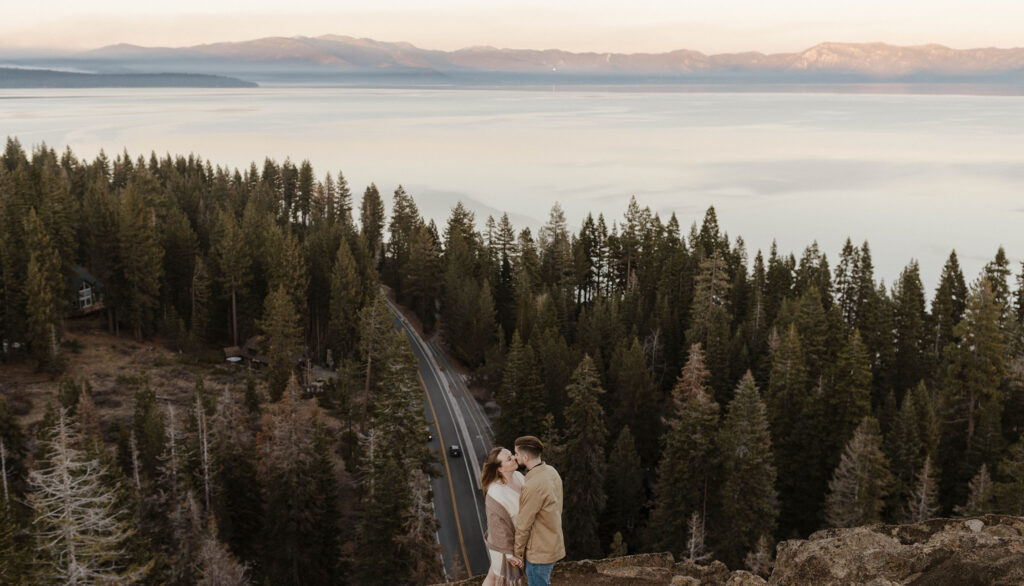 couple kissing at eagle rock in lake tahoe at sunset