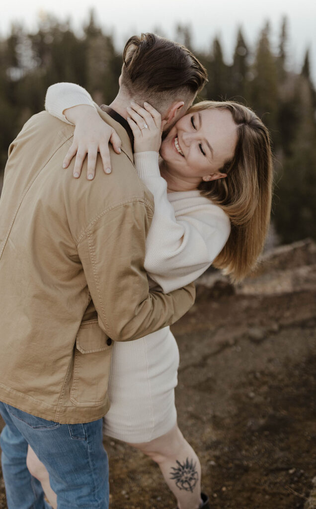 couple hugging and smiling at eagle rock lake tahoe