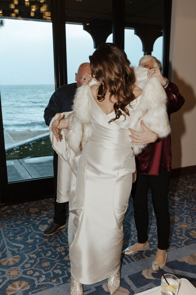 bride putting on a fur coat 