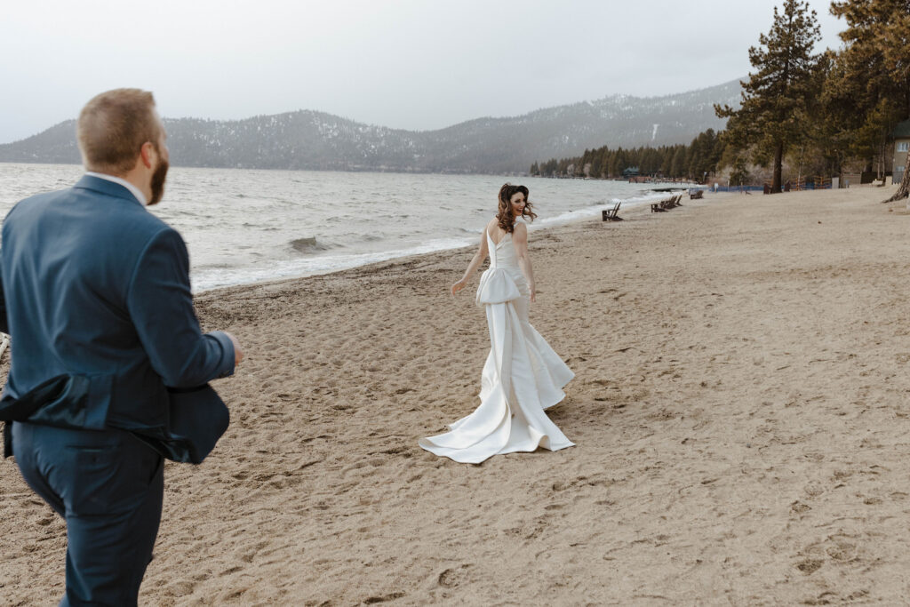 groom chasing the bride on the beach at the hyatt in lake tahoe 