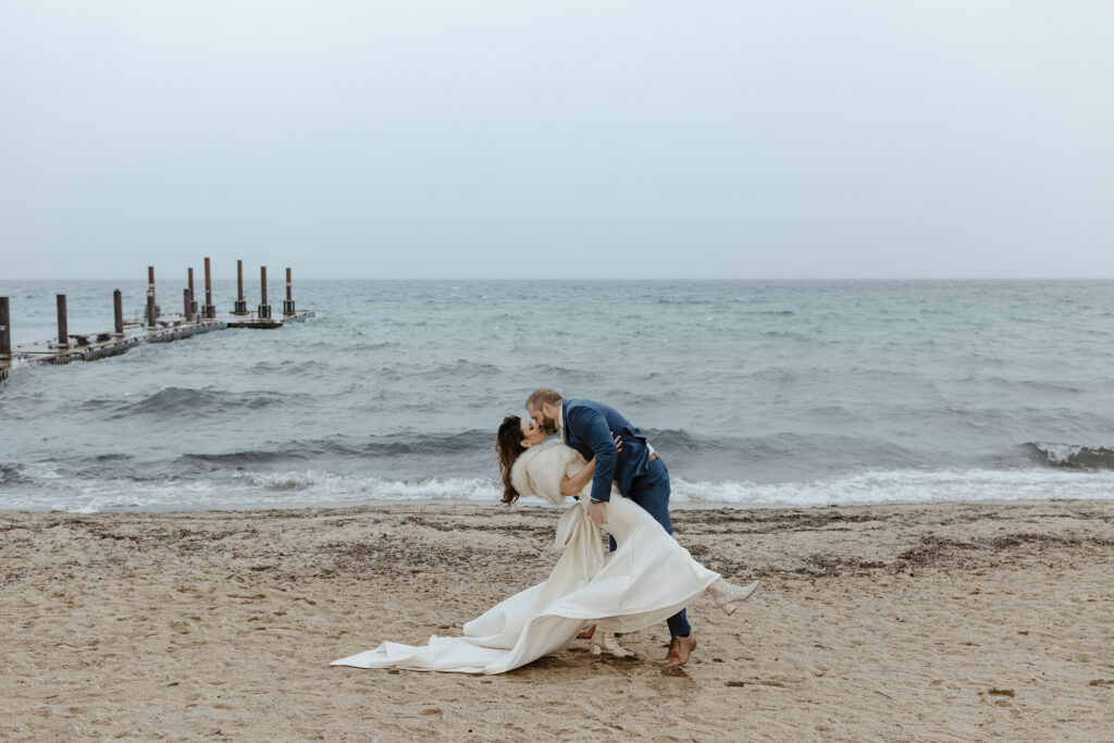 bride and groom doing the dip kiss pose in lake tahoe 