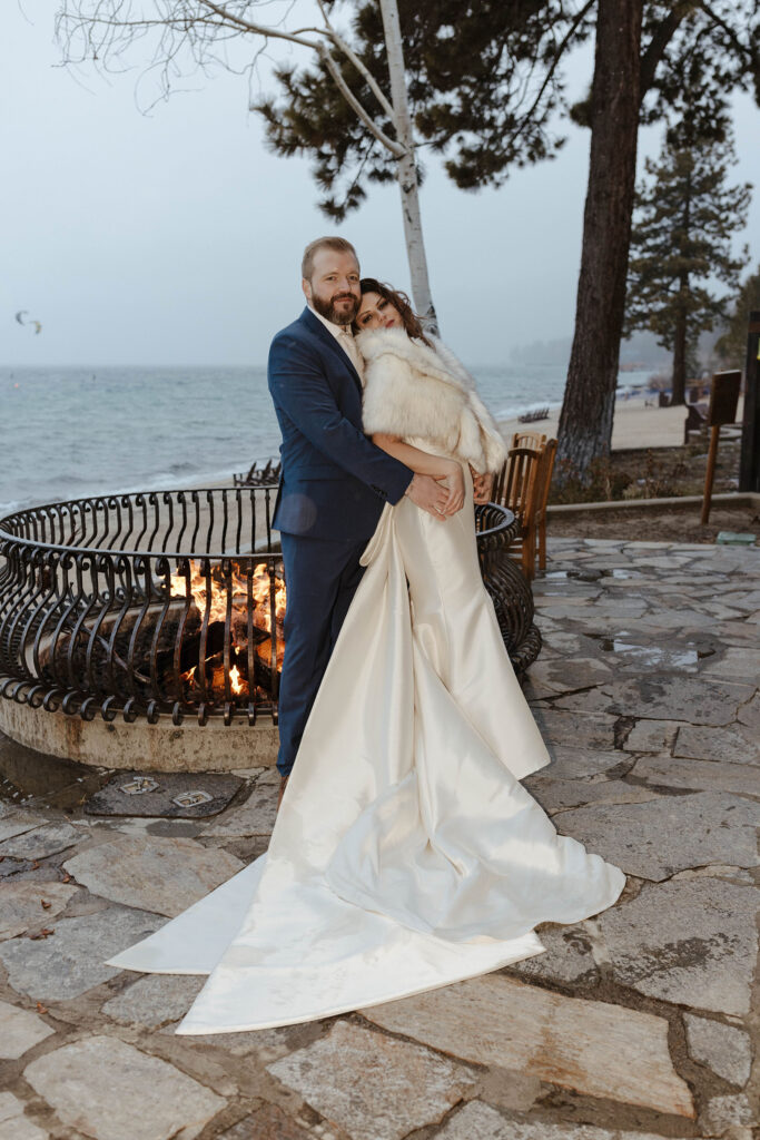 newlyweds standing by the fire at the hyatt in lake tahoe 