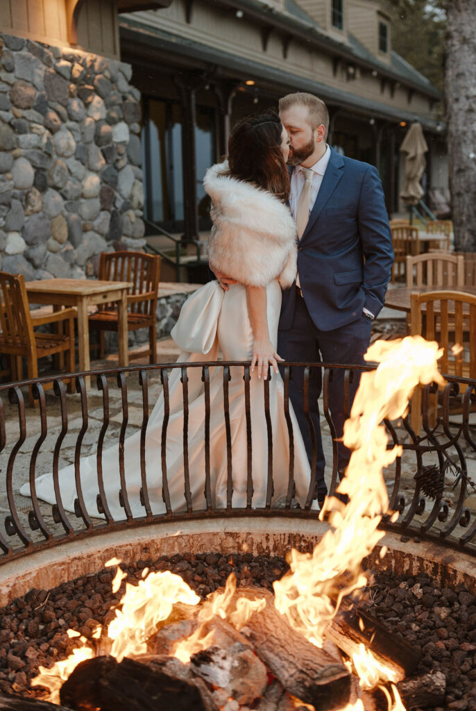newlyweds kissing by the fire at the hyatt in lake tahoe 