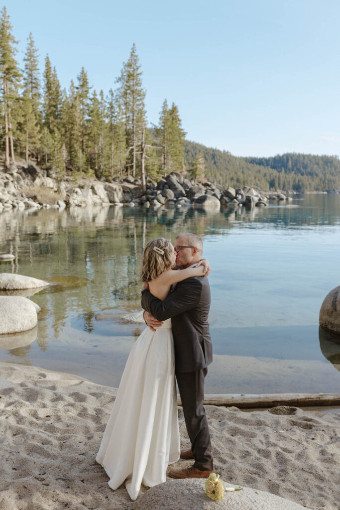 wedding couple kissing on the beach in lake tahoe 