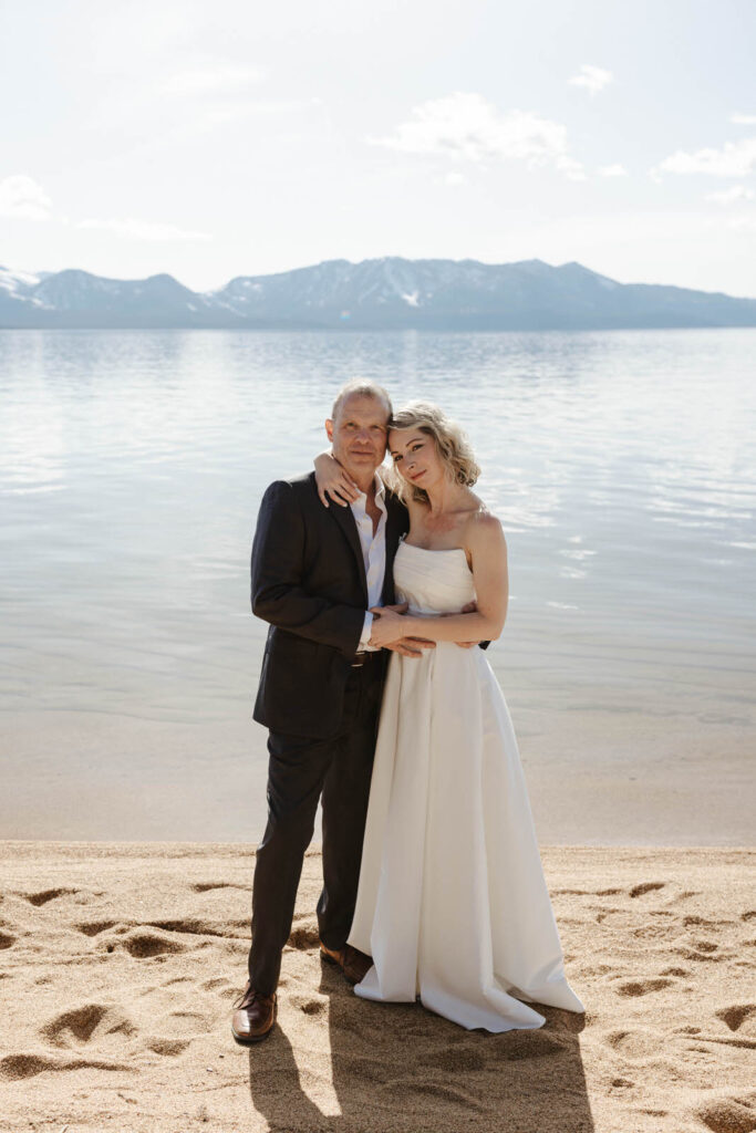 elopement couple looking at the camera on the beach in lake tahoe