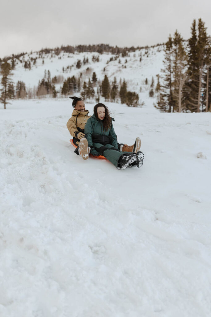 couple sledding at mount rose meadows