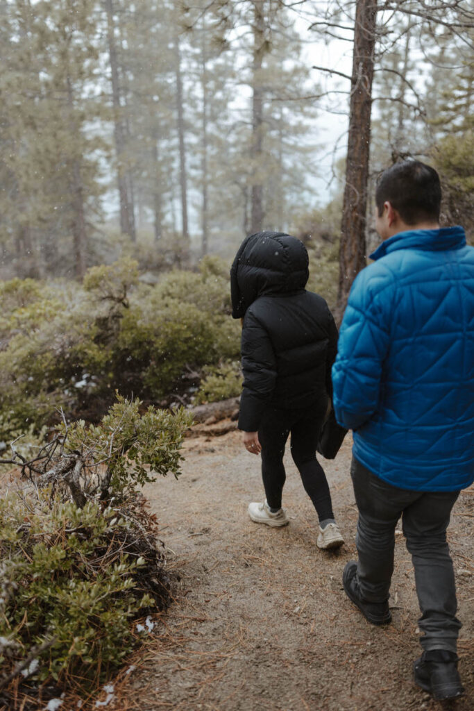 couple walking through lake tahoe in the winter