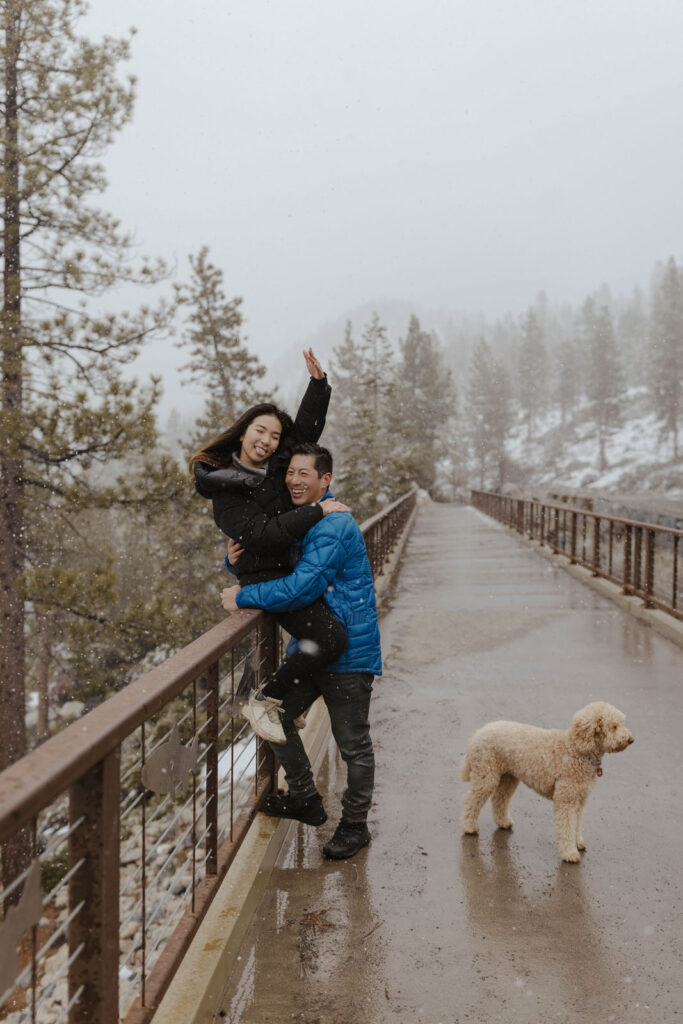 couple excited throwing hands up in lake tahoe