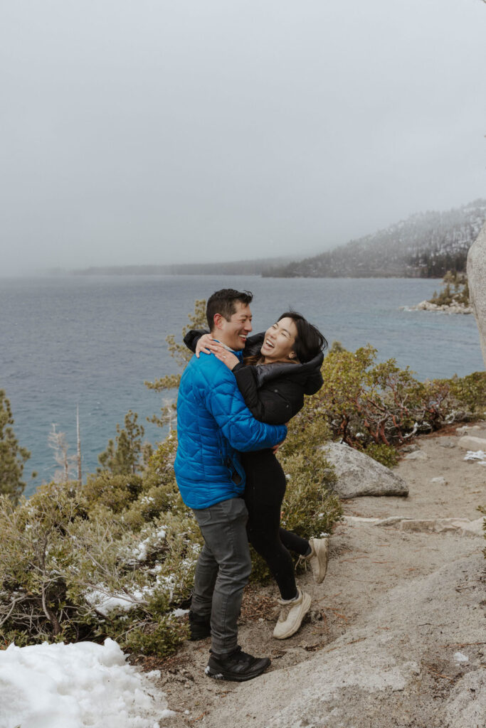 couple hugging and laughing in lake tahoe