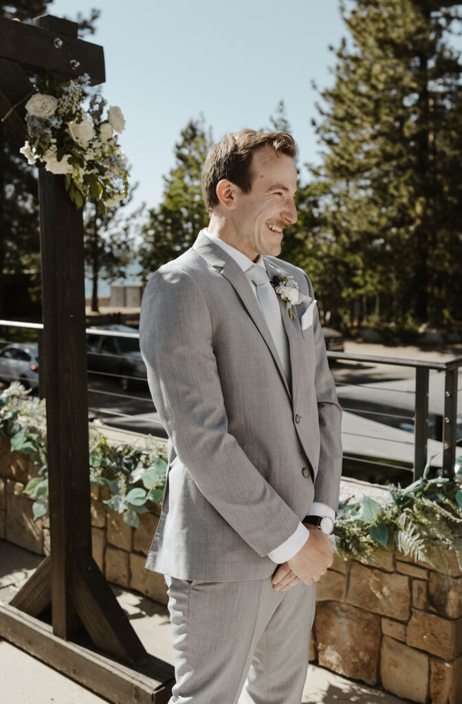 groom smiling at his bride during his ceremony at the landing resort and spa