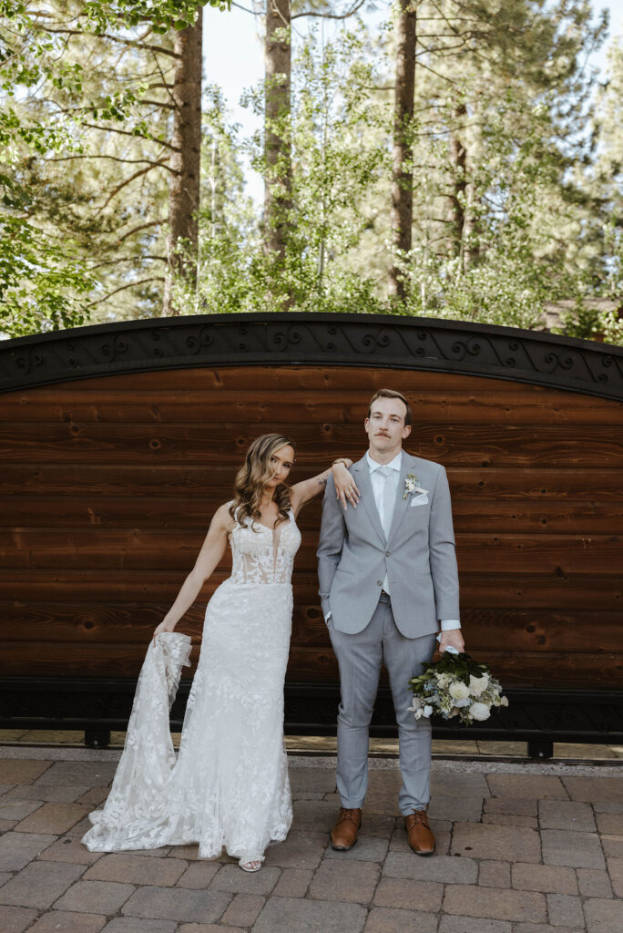 bride and groom leaning on each other looking at the camera at the landing resort and spa