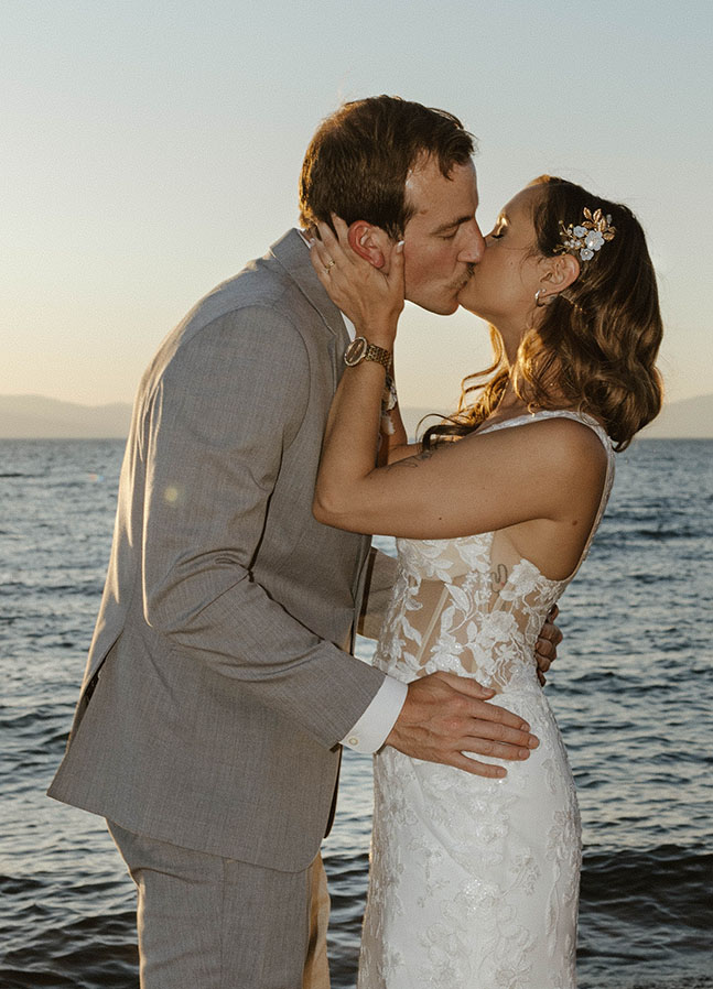 newlyweds kissing with lake tahoe in the background