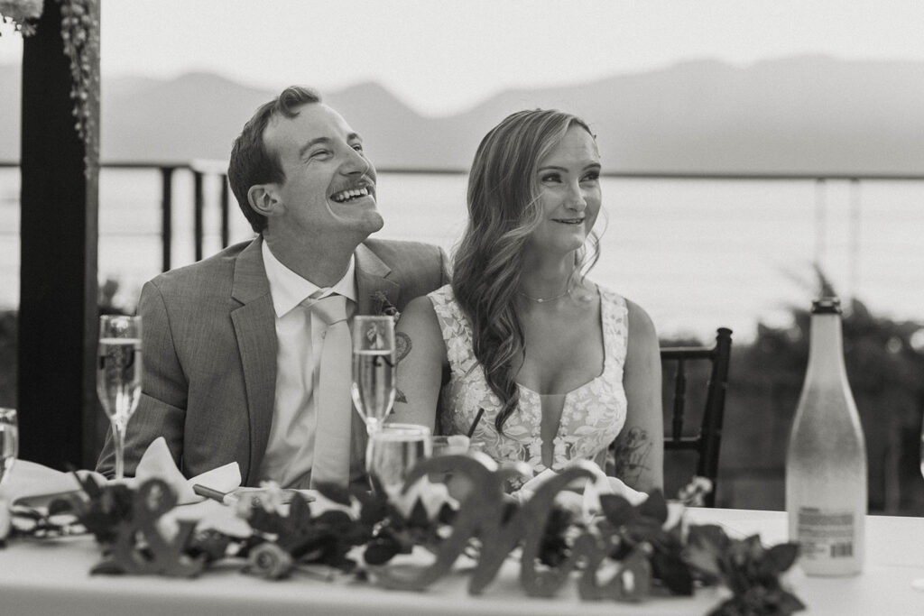 wedding couple laughing during speeches at their landing resort and spa wedding