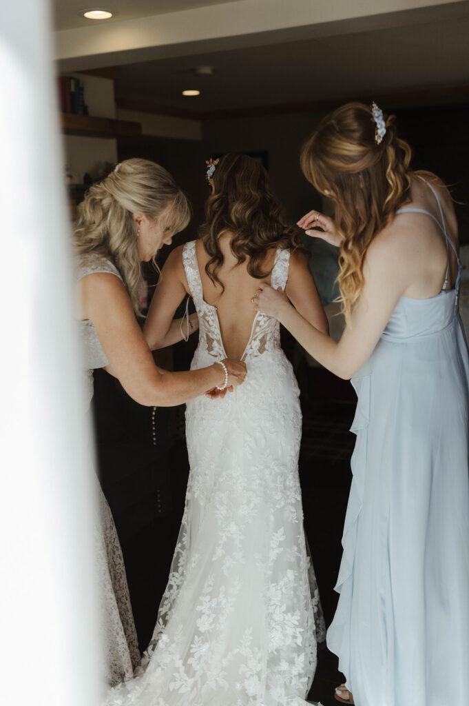 bride getting into wedding dress at the landing resort and spa