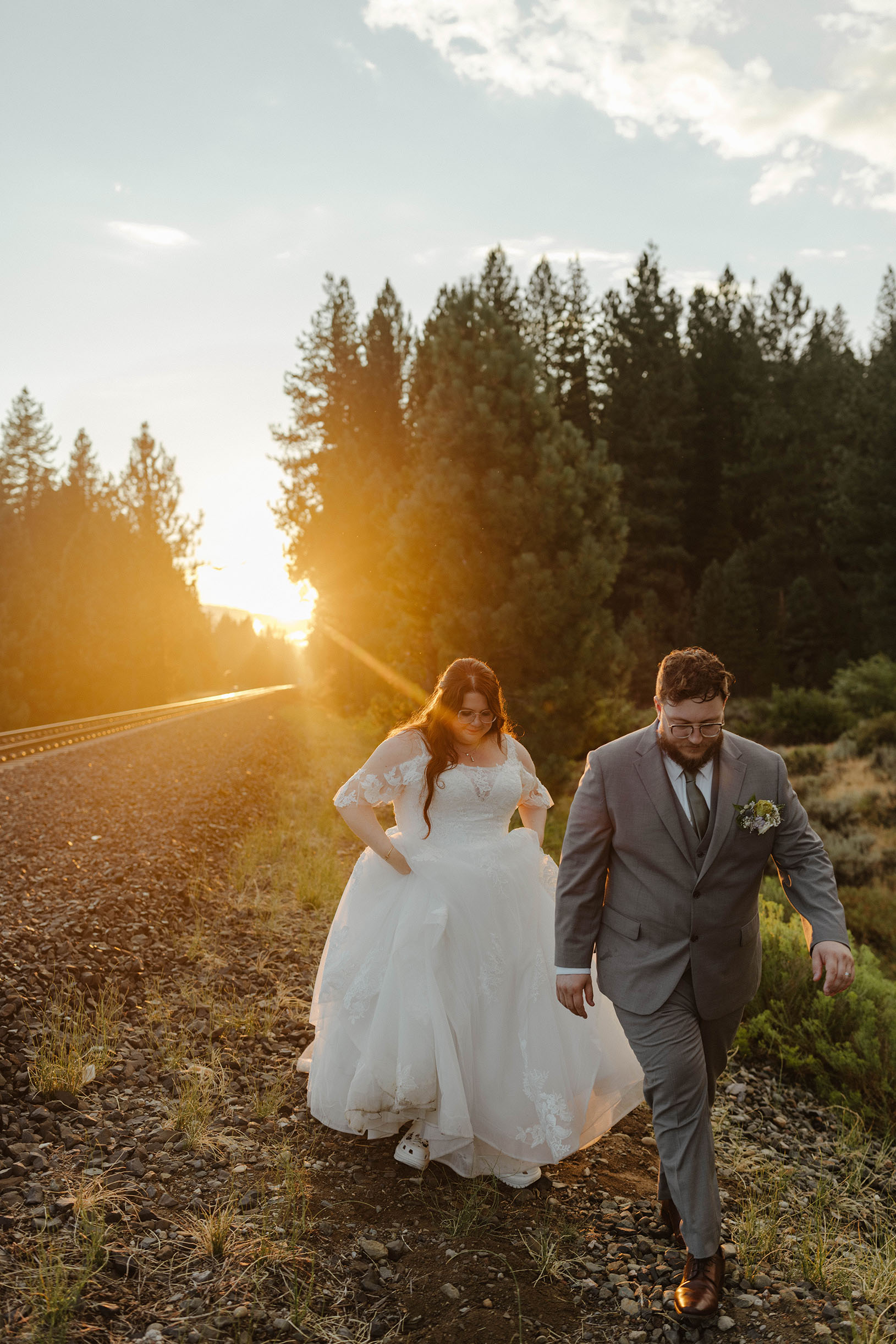 wedding couple walking at sunset at the corner barn