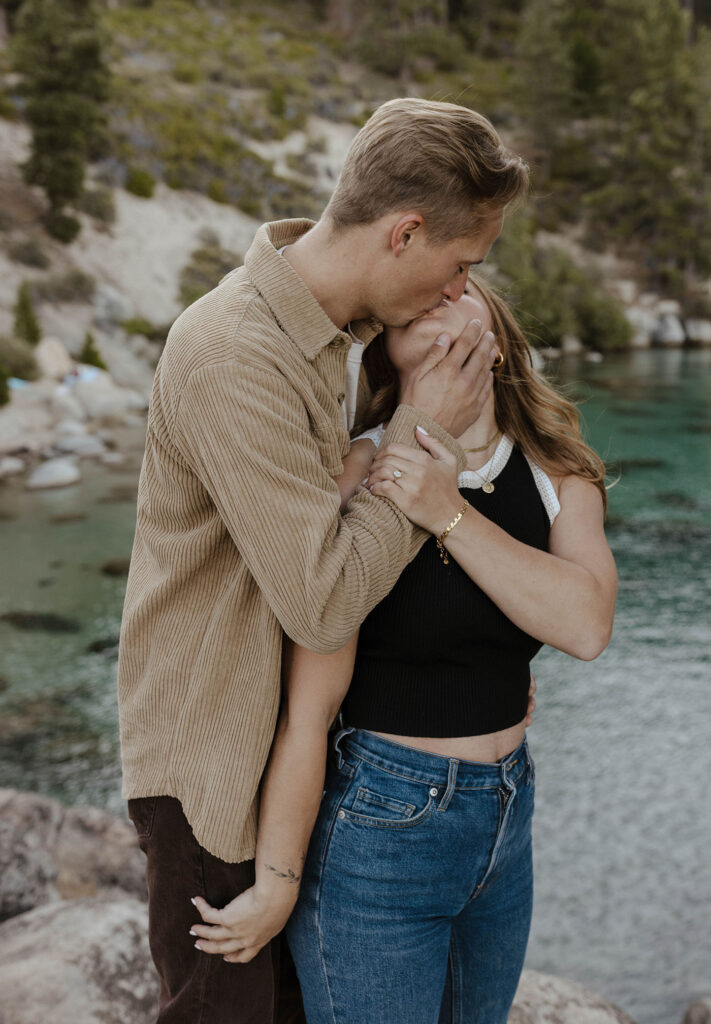 couple kissing and holding each other in lake tahoe