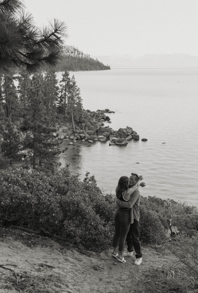 couple hugging overlooking the water in lake tahoe 