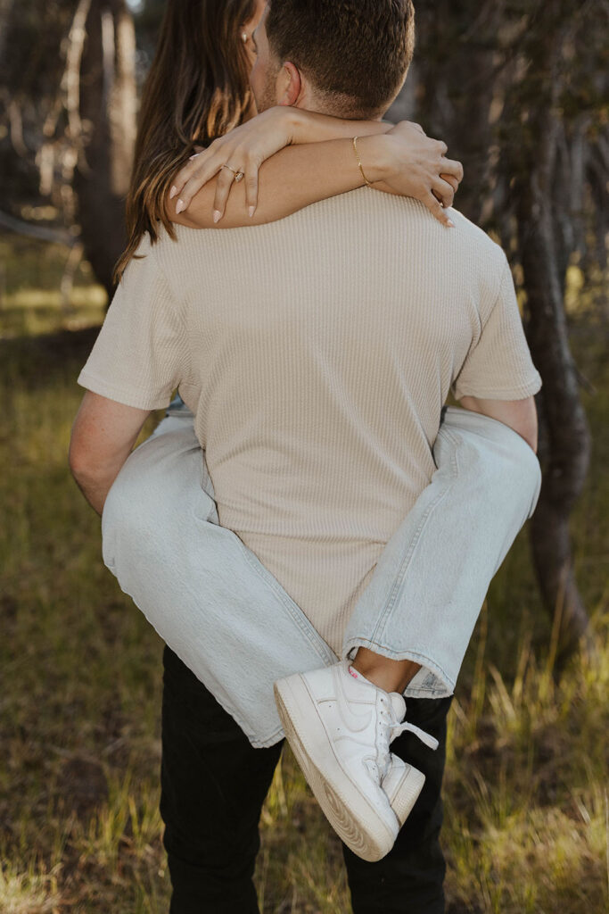 woman wrapping her arms around her fiance hugging him