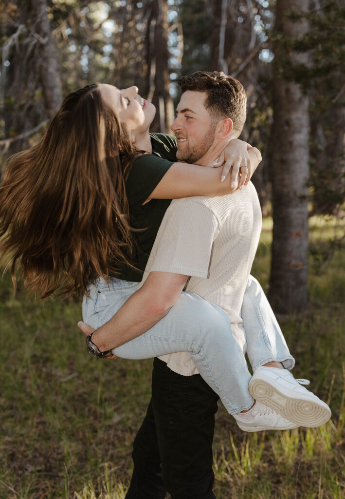 man holding and spinning woman as she laughs 