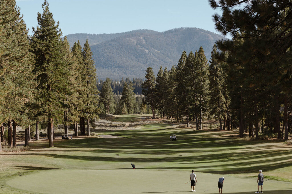 Golfers playing golf on green grass at Timbers at Old Greenwood