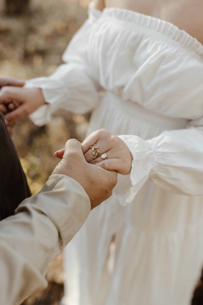 Close up of engagement couple holding hands and engagement ring on woman's hand in Truckee