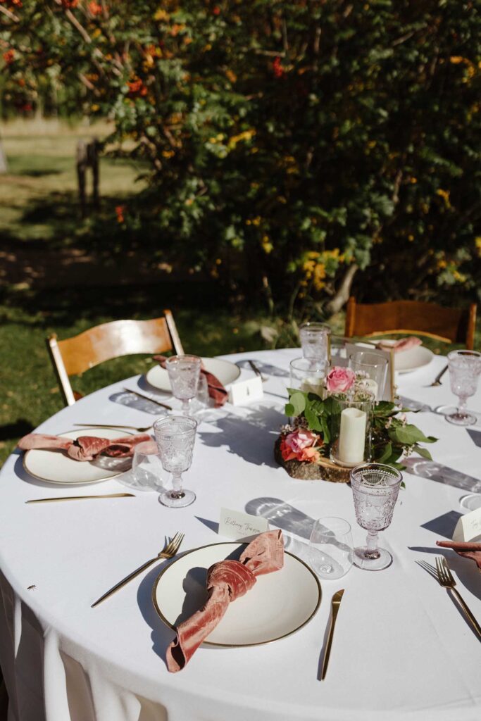 Wedding dinner table with pink colored napkin and gold utensils at Valhalla in Lake Tahoe