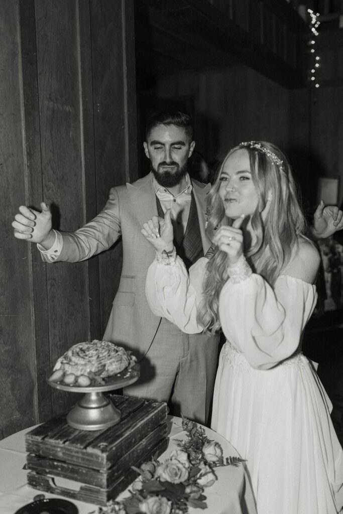 Wedding couple celebrating after taking bite of wedding cake together during reception at Valhalla in Lake Tahoe