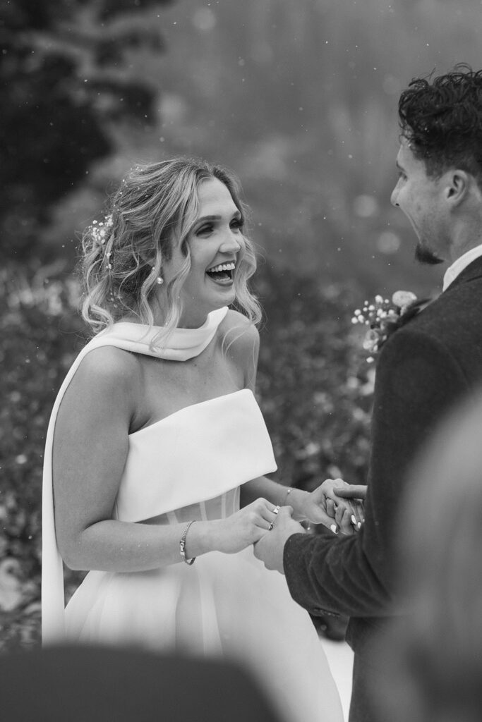Bride smiling while holding hands with groom during elopement ceremony in Emerald Bay