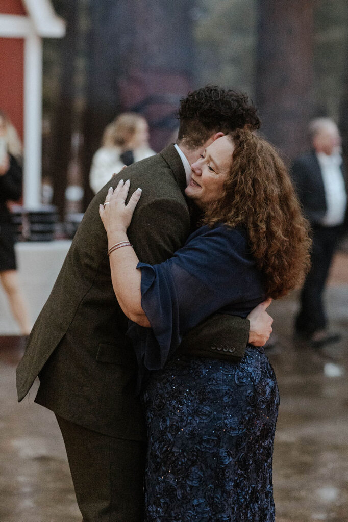 Groom hugging mom after first dance during elopement reception in Emerald Bay