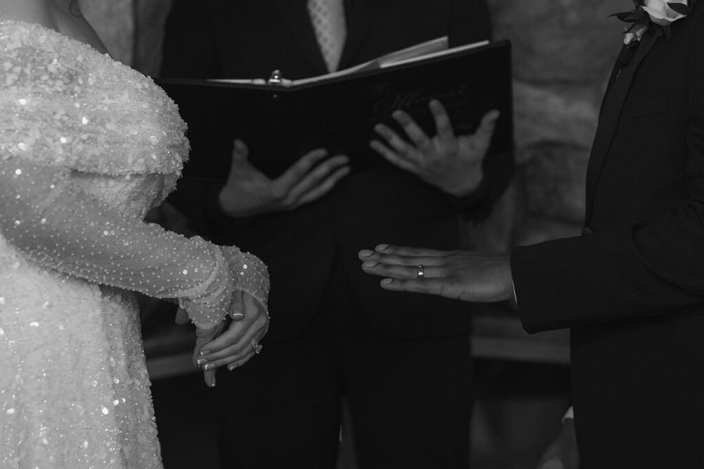 Groom holding hand out with ring on finger during wedding ceremony at the Tannenbaum