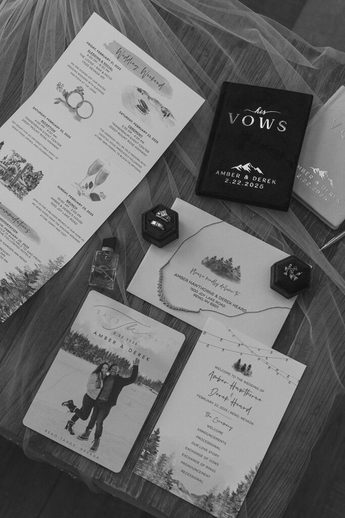Flat lay of wedding details with vow books and announcements on thin veil during winter wedding at the Tannenbaum