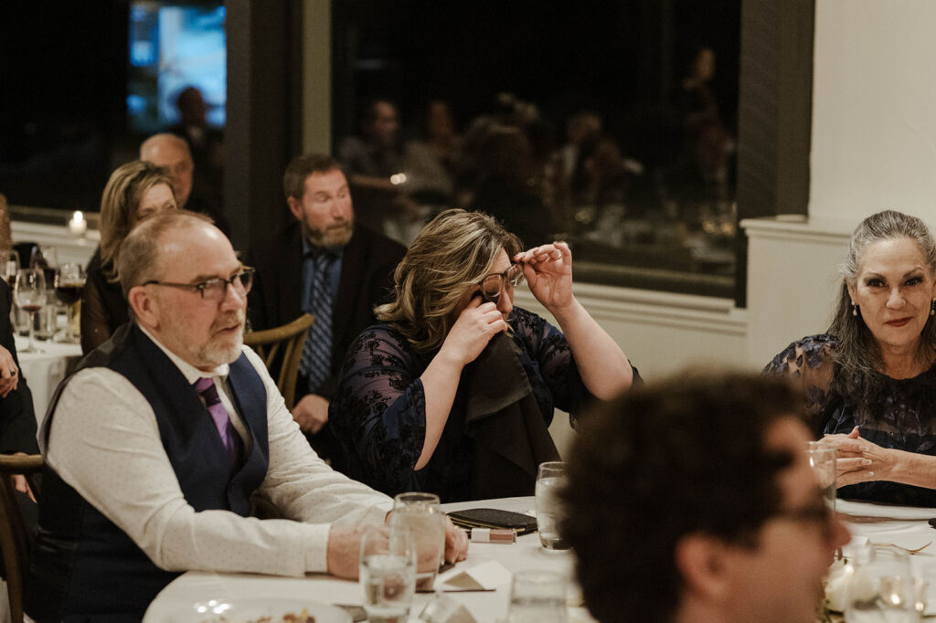 Wedding guest emotional and wiping tears during reception at the Tannenbaum
