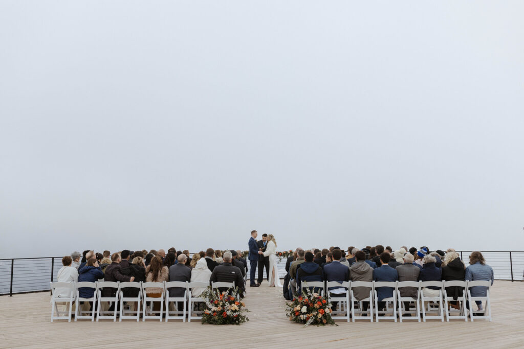 Overview of wedding ceremony on overlook at High camp at Palisades Tahoe