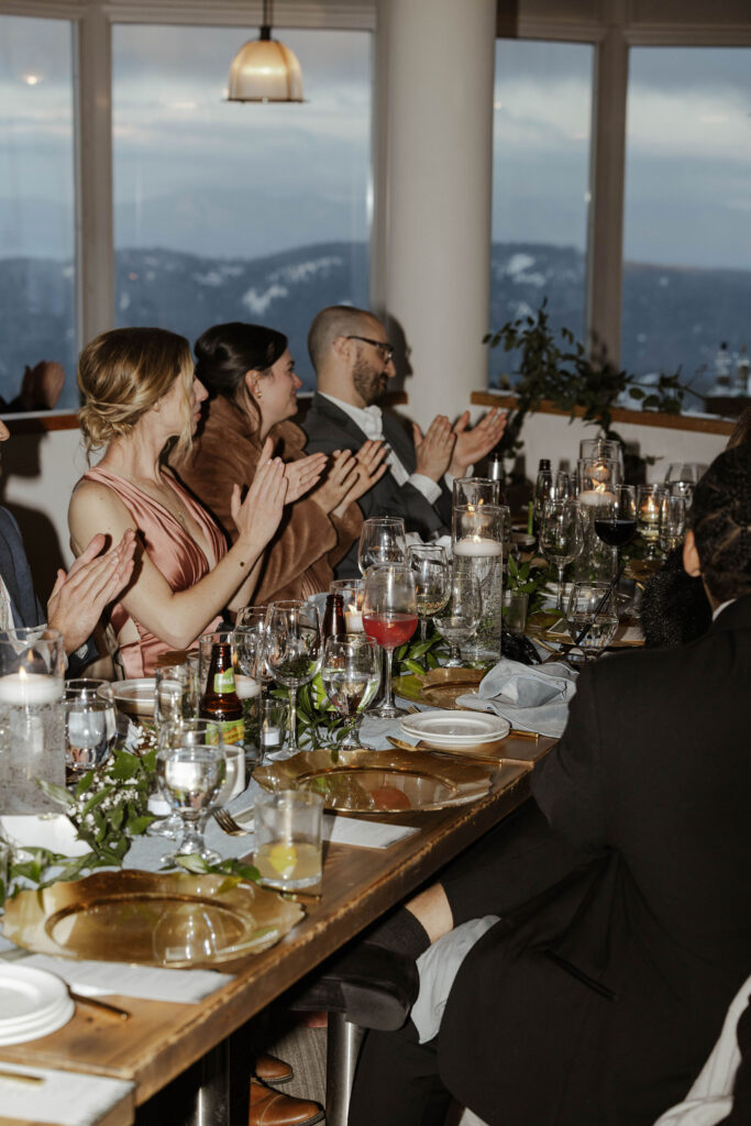 Guests clapping during speeches at wedding reception at Palisades Tahoe