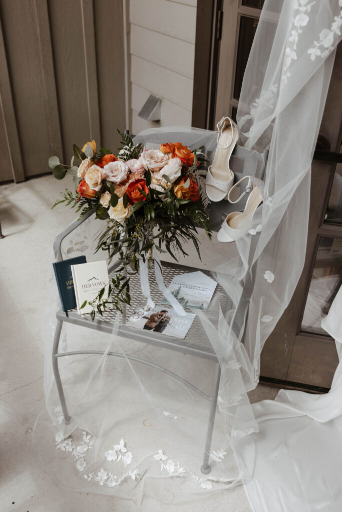 Floral bouquet on chair next to wedding shoes and details at Palisades Tahoe