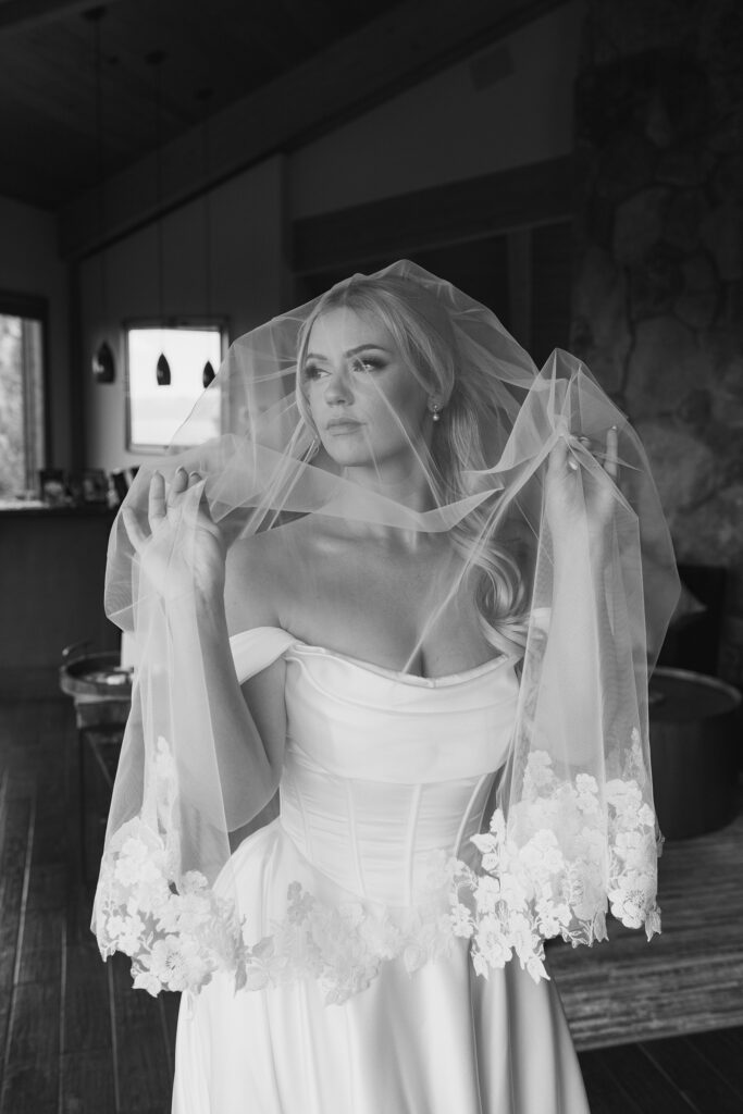 bride holding a lace veil over her face at tahoe blue estate
