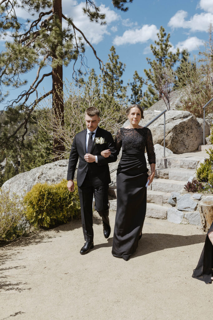 the groom walking to his ceremony with his mom at tahoe blue estate