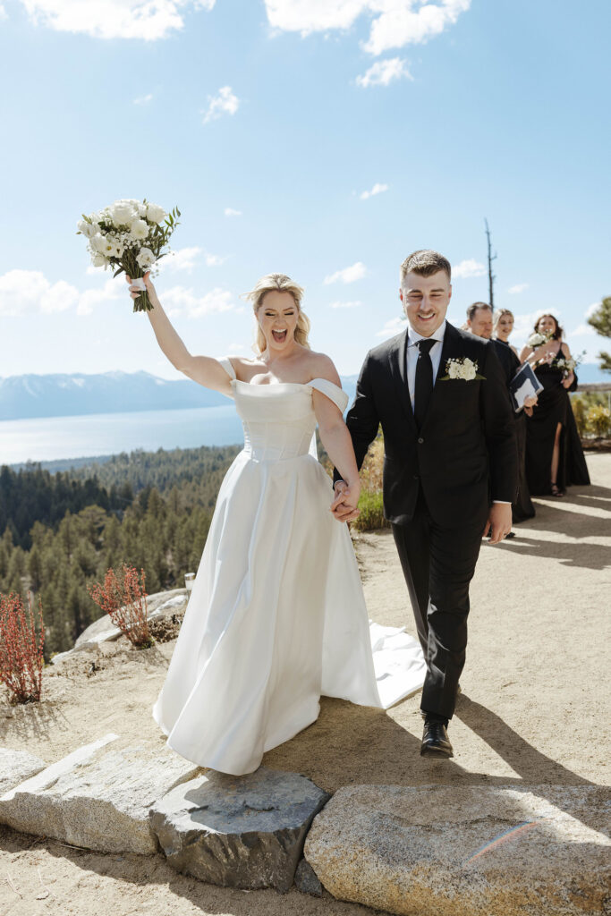 bride and groom cheering that they just got married with their hands in the air at tahoe blue estate