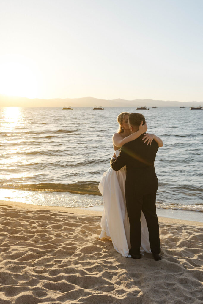 wedding couple hugging and kissing at riva grill at sunset 