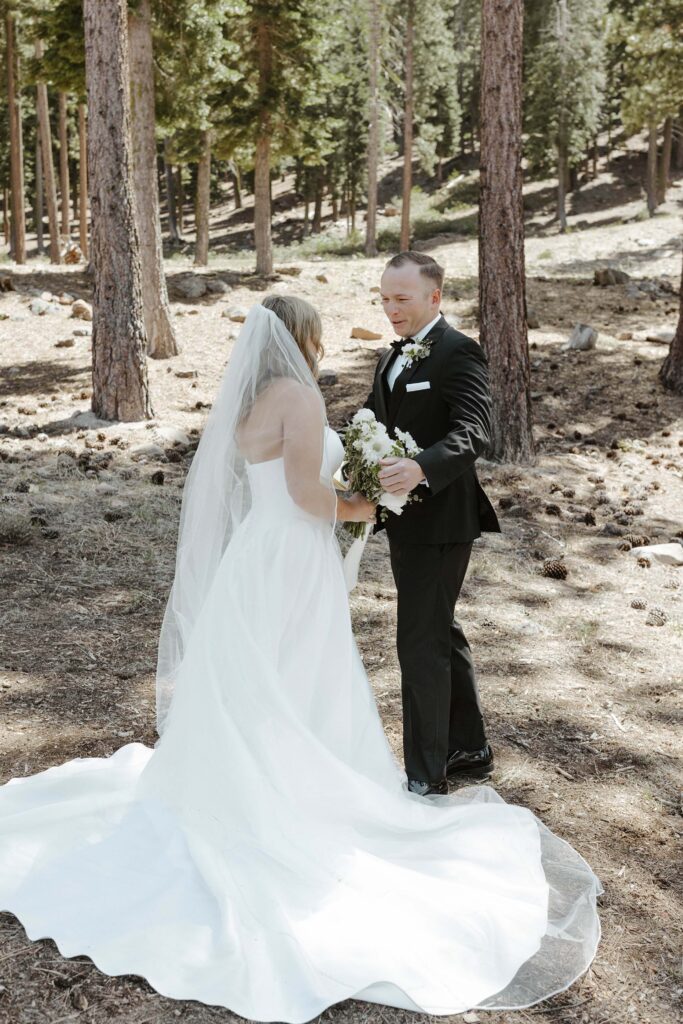 groom emotional going in for a hug to embrace his bride during a first look in donner lake 